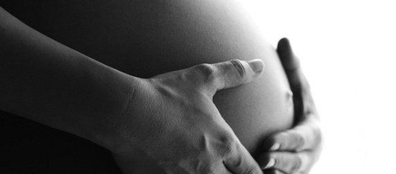 pregnant woman's stomach and hands