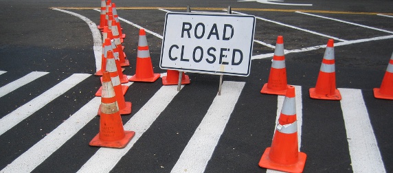 road closed sign and traffic cones