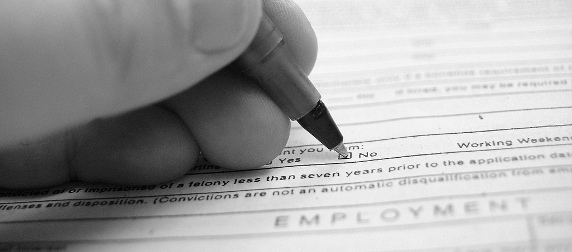 close-up of a hand filling out a job application form