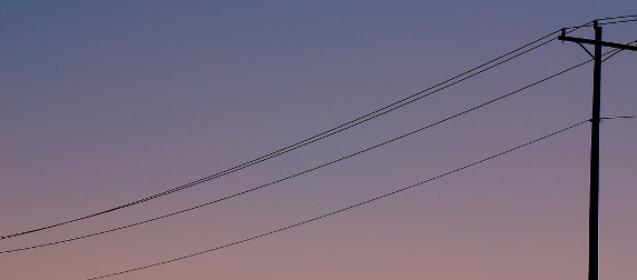 telephone lines against a sky at sunset