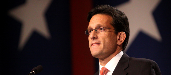 Eric Cantor at a podium, in front of a flag background