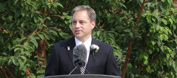 Sean Parnell speaks at an outdoor podium