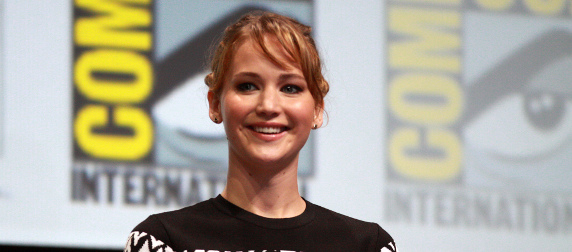 Jennifer Lawrence in front of a San Diego Comic Con banner