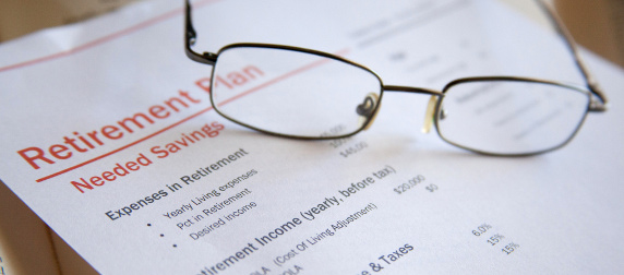 glasses resting on a document titled 'Retirement Plan'