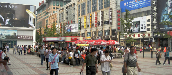 shoppers walking along a busy street in Beijing