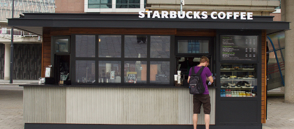 customer with backpack making a purchase at Starbucks in Amsterdam Sloterdijk station