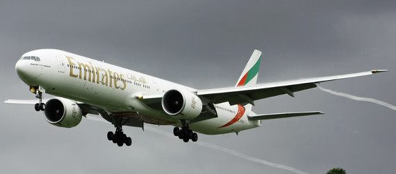 Emirates 777 plane taking off against an overcast sky