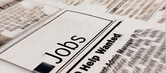 newspaper column with a Jobs heading and Help Wanted subhead, blurred edges