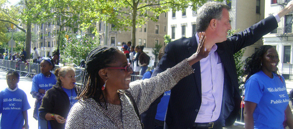 Chirlane McCray and Bill de Blasio waving to supporters