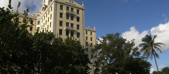 facade of the National Hotel of Cuba rising among trees against a blue sky