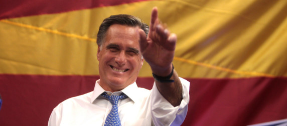 Mitt Romney in front of a red and yellow backdrop