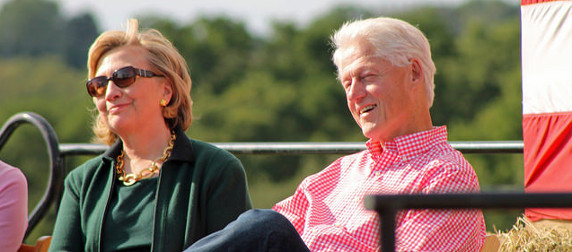 Bill and Hillary Clinton, in casual dress, smiling