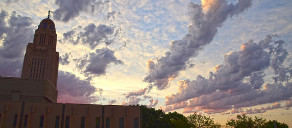 Nebraska Capitol building, viewed against a sky at dawn