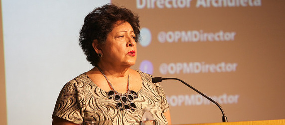 Katherine Archuleta speaking at a podium