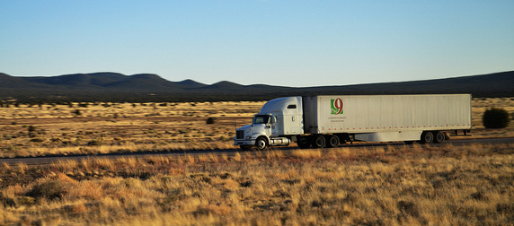 white semitrailer with a Pac 9 logo driving through a desert landscape