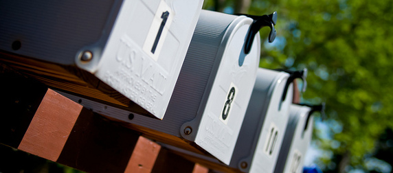 close view of a row of gray mailboxes