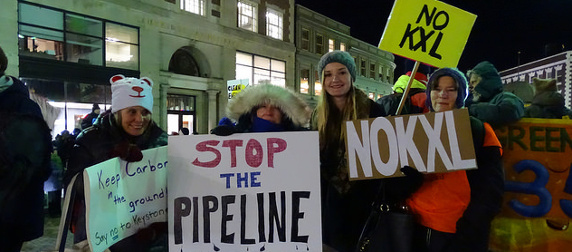 protesters holding anti-Keystone XL Pipeline signs