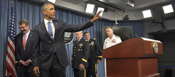 President Obama waving as he departs a press briefing at the Pentagon