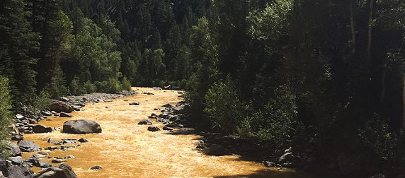 The Animas River, Colorado, displaying an orange-yellow color after the Gold King Mine spill in August 2015