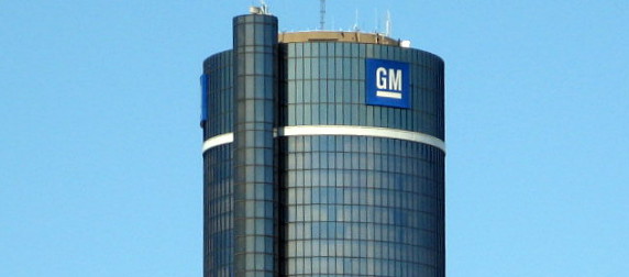 GM logo on a building against a blue sky