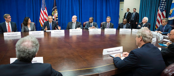 Barack Obama addressing agriculture and business leaders at a large oval table