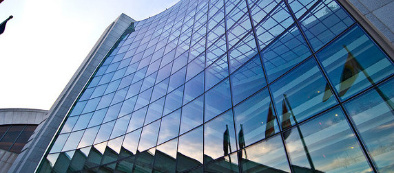 The Securities and Exchange Commission facade, reflecting a row of flags