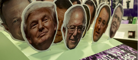 cutouts of the faces of various 2016 presidential candidates, prominently including Donald Trump and Bernie Sanders