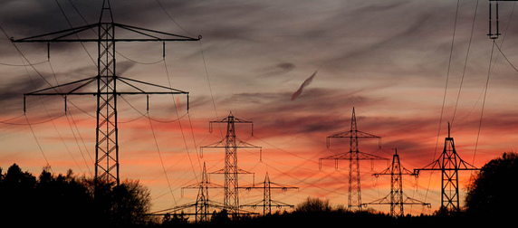 electrical towers against a sunset