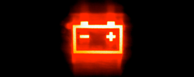red car battery light illuminated against a black background