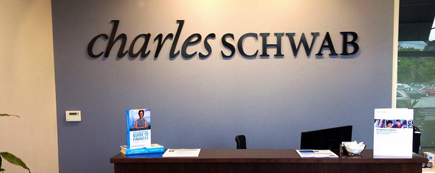 reception desk with Charles Schwab sign on the wall behind it