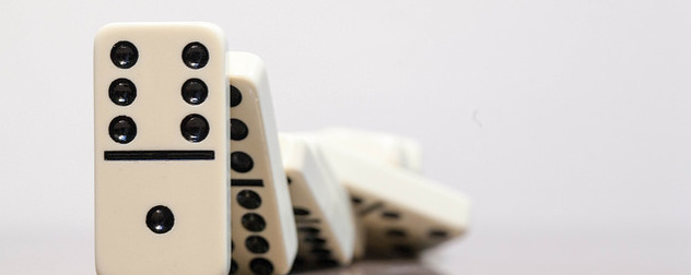 line of falling dominoes against a white background