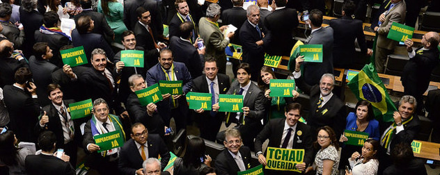 members of Brazil's Chamber of Deputies holding pro-impeachment signs on the Chamber floor