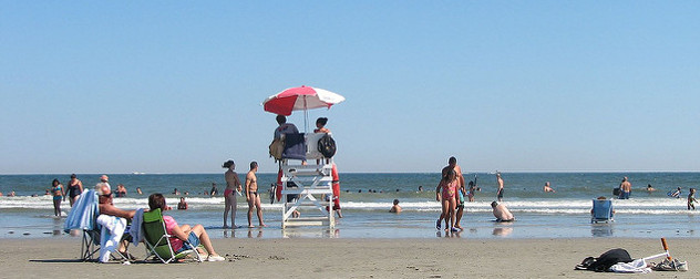 lifeguards and beachgoers on a sunny day