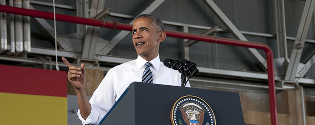 Barack Obama, speaking at a podium adorned with the presidential seal