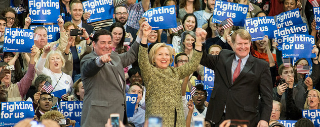 Hillary Clinton, center, holding hands with Pittsburgh Mayor Bill Peduto and Allegheny County Executive Rich Fitzgerald in the midst of supporters at a rally