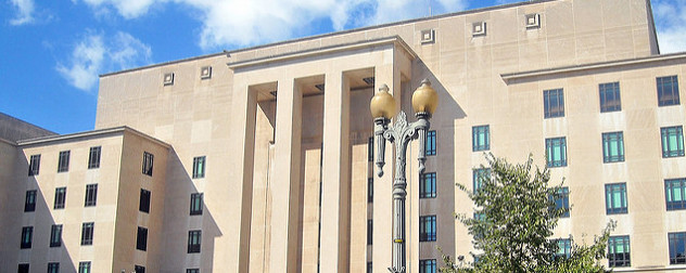 facade of the Harry S Truman Building against a blue sky