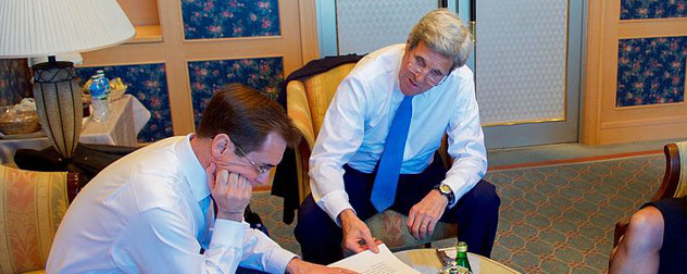 John Kirby and John Kerry, seated in shirtsleeves