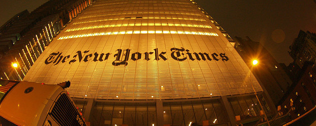 ground-level view of the New York Times building illuminated at night