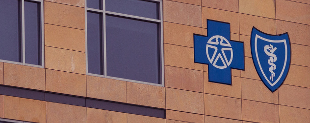Blue Cross Blue Shield logo on the side of a brick building