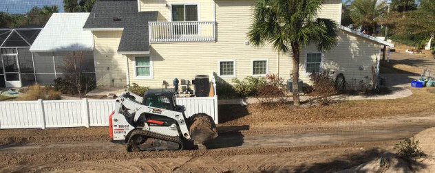 Plow clearing sand from a residential street