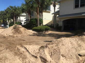 beach property's driveway with sand removed