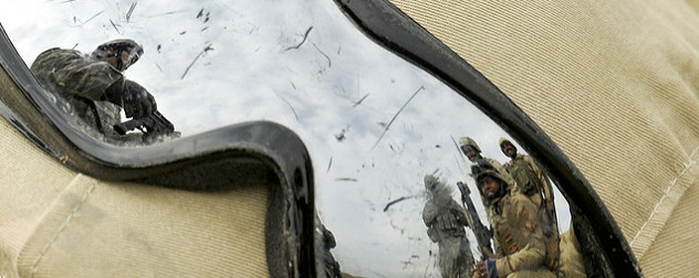 U.S. Army Staff Sergeant instructs Iraqi troops, reflected in a pair of reflective goggles