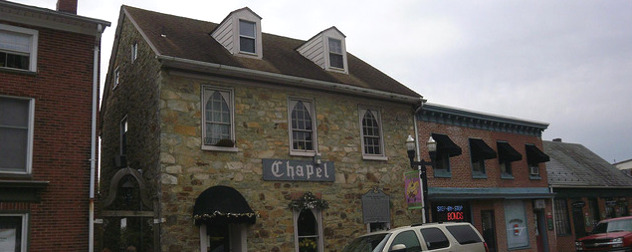 brick facade of two-story building with the word 'Chapel' on the front