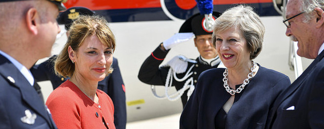 PM Theresa May greeted on her arrival to Italy