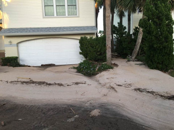 beach property's driveway filled with sand