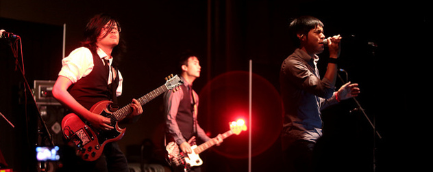 three members of the band The Slants performing onstage