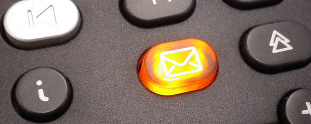 detail of orange illuminated voicemail button on a phone