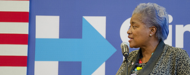 Donna Brazile speaking in front of a Hillary Clinton campaign banner