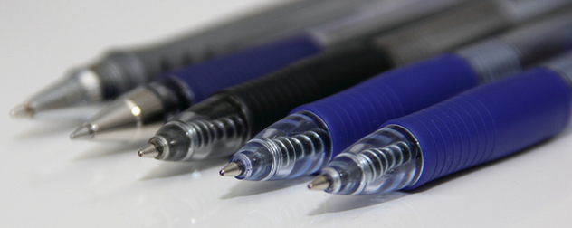 detail of a row of uncapped ballpoint pens