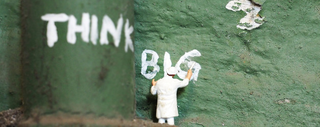 miniature figurine of a painter below the words 'Think Big'